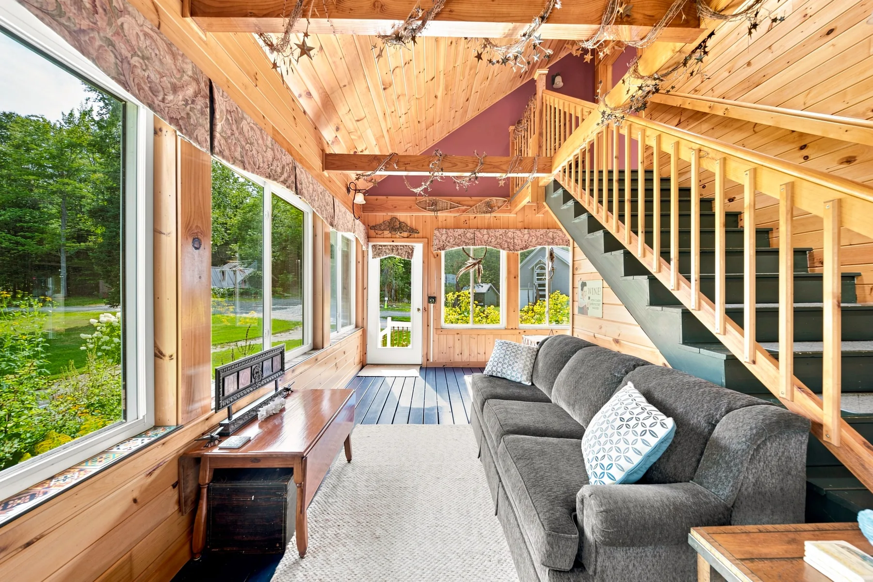Wood-lined living room with broad views across the property